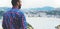 Hipster young man looking on observation deck in trip holiday in Bilbao, enjoying view on seascape on mountain and ocean, tourist