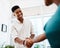 Hire people who have the same ambition as you. a young businessman and businesswoman shaking hands in a modern office.