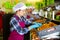 Hired farm worker in protective mask checks and sorts peaches in warehouse