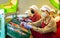 Hired farm worker in protective mask checks and sorts peaches in warehouse