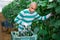 Hired latino worker picks crop of cucumbers in greenhouse