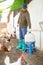 Hired male worker repairing chicken feeders in poultry farm