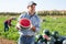 hired worker with half a watermelon in her hands posing in farmer field