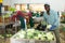 Hired worker sorts fresh cabbage in the warehouse of vegetable processing factory