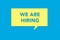 We are hiring message on a yellow sticky note on a blue background