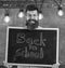 Hiring teachers concept. Man with beard and mustache on happy face welcomes colleagues, chalkboard on background