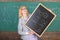 Hiring teachers for new school year. Woman teacher holds blackboard inscription back to school. Looking committed