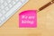 We are hiring text on a sticky note with a keyboard
