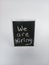 We are hiring written on a chalkboard on a white background