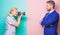 His confidence is her focus. Photographer shooting male model in studio. Businessman posing in front of female