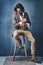 His confidence shines through his style. Studio shot of a handsome young man posing against a grey background.