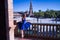 Hispanic adult female classical ballet dancer in blue tutu doing figures on the terrace of a plaza next to a beautiful tiled