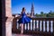 Hispanic adult female classical ballet dancer in blue tutu doing figures on the terrace of a plaza next to a beautiful tiled