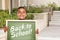 Hispanic Boy Holding Back To School Chalk Board on School Campus