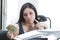 Hispanic brunette office woman sitting by desk