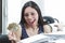 Hispanic brunette office woman sitting by desk