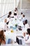 Hispanic Businesswoman Leading Meeting At Boardroom Table