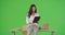 A Hispanic businesswoman works on her tablet on green screen