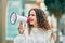 Hispanic child girl shouting angry using megaphone at the city