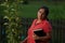 Hispanic Christian Woman by Pear Tree and her Bible