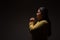 Hispanic Christian Woman Praying or Talking to God on Dark Background