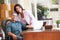 Hispanic Couple Using Laptop On Desk At Home