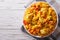 Hispanic cuisine: Arroz con pollo close up in a bowl. Horizontal