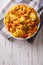 Hispanic cuisine: Arroz con pollo close up in a bowl. vertical t