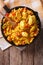 Hispanic cuisine: Arroz con pollo in a pan. vertical top view