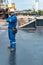 Hispanic deck officer on ship deck, with PPE personal protective equipment. Dream job at sea