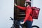 Hispanic delivery man with electric bike ringing the doorbell - Focus on face