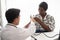 Hispanic doctor measuring African American patient\'s blood pressure. Person medical healthcare and wellbeing,??.