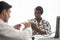 Hispanic doctor measuring African American patient\'s blood pressure. Person medical healthcare and wellbeing, the physician