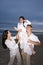 Hispanic family with daughter having fun on beach