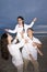 Hispanic family with daughter having fun on beach