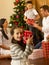 Hispanic family exchanging gifts at Christmas