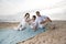 Hispanic family with little girl on beach blanket