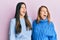 Hispanic family of mother and daughter wearing wool winter sweater angry and mad screaming frustrated and furious, shouting with
