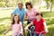 Hispanic family riding bikes in park