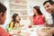 Hispanic Family At Table Eating Meal Together
