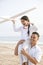 Hispanic father and daughter having fun on beach