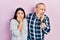 Hispanic father and daughter wearing casual clothes looking stressed and nervous with hands on mouth biting nails