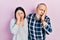 Hispanic father and daughter wearing casual clothes yawning tired covering half face, eye and mouth with hand