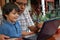 Hispanic father and son on laptop