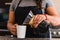 Hispanic female barista pouring coffee