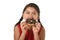 Hispanic female child in red dress eating chocolate donut with hands and mouth stained and dirty smiling happy