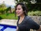 Hispanic girl enjoying a holiday in the pool with a smiley face and wet hair