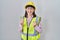 Hispanic girl wearing builder uniform and hardhat very happy and excited doing winner gesture with arms raised, smiling and