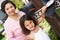 Hispanic Grandmother And Granddaughter Checking Mailbox