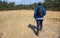 A Hispanic hiker walking on a field near mount Tlaloc in Mexico